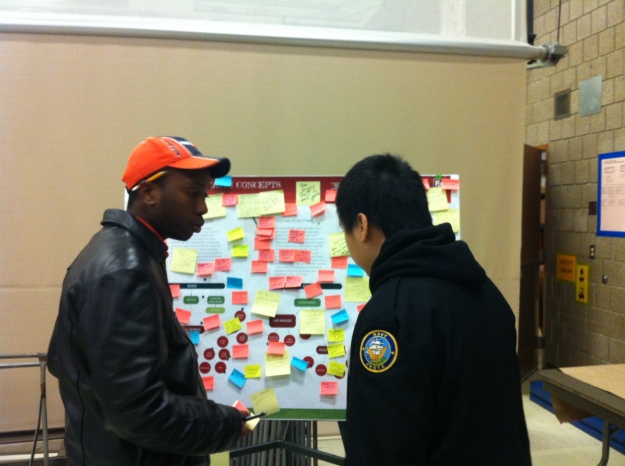 Community Ambassadors Abdi and Chong staff the program feedback station.